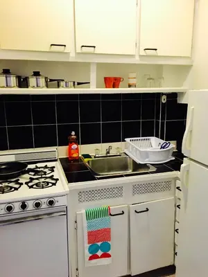 a kitchen with a white stove and a sink at Stylish Montreal Apartment: Comfortable Stay in the Golden Square Mile in Montréal