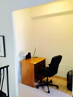 an office with a desk and a chair at Stylish Montreal Apartment: Comfortable Stay in the Golden Square Mile in Montréal