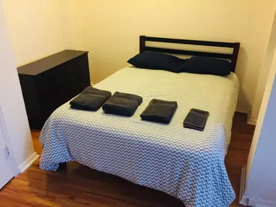 a bedroom with a bed with two pillows on it at Stylish Montreal Apartment: Comfortable Stay in the Golden Square Mile in Montréal