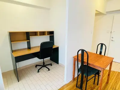 an office with a desk and two chairs and a table at Stylish Montreal Apartment: Comfortable Stay in the Golden Square Mile in Montréal