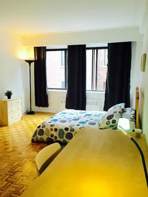 a bedroom with a bed and a table at Stylish Montreal Apartment: Comfortable Stay in the Golden Square Mile in Montréal
