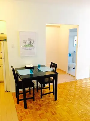 a dining room with a table and two chairs at Stylish Montreal Apartment: Comfortable Stay in the Golden Square Mile in Montréal