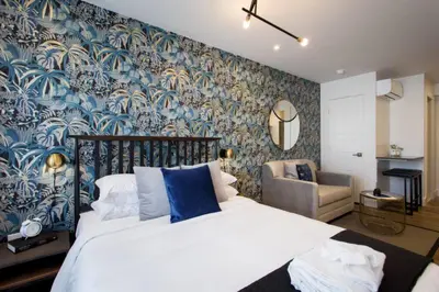 a bedroom with a bed with a blue and white wallpaper at 6768 - 202 Amazing mini studio with full kitchen by Denstays in Montréal