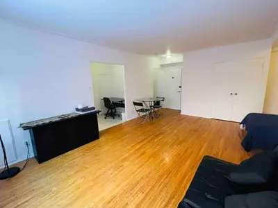 an empty living room with a table and a couch at Stylish Montreal Apartment: Comfortable Stay in the Golden Square Mile in Montréal