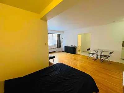 an empty room with a table and chairs in it at Stylish Montreal Apartment: Comfortable Stay in the Golden Square Mile in Montréal