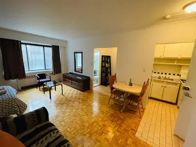 a living room with a couch and a table at Stylish Montreal Apartment: Comfortable Stay in the Golden Square Mile in Montréal