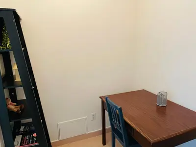 a dining room table with a chair and a book shelf at Stylish Montreal Apartment: Comfortable Stay in the Golden Square Mile in Montréal
