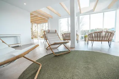 a living room with chairs and a couch and a rug at MiniBora Le ciel - Cantons-de-l'Est in Bury