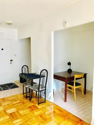 a dining room with a table and chairs at Stylish Montreal Apartment: Comfortable Stay in the Golden Square Mile in Montréal
