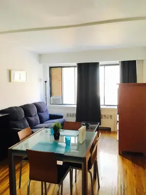 a living room with a table and a couch at Stylish Montreal Apartment: Comfortable Stay in the Golden Square Mile in Montréal