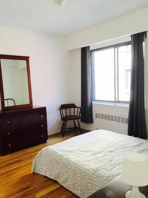 a bedroom with a bed and a mirror and a dresser at Stylish Montreal Apartment: Comfortable Stay in the Golden Square Mile in Montréal
