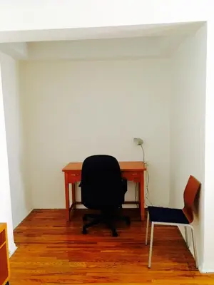 an office with a desk and a chair and a chair at Stylish Montreal Apartment: Comfortable Stay in the Golden Square Mile in Montréal