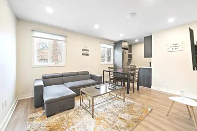 a living room with a couch and a table at DUPLEX 6 BEDROOMS IN HEART OF PLATEAU MONT-ROYAL in Montréal