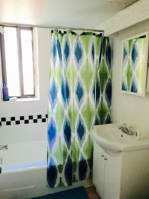 a bathroom with a shower curtain and a sink at Stylish Montreal Apartment Comfortable Stay in the Golden Square Mile in Montréal