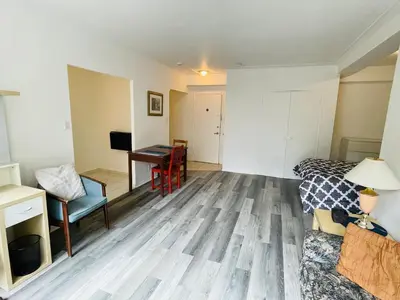 a room with a bed and a desk and a bed at Stylish Montreal Apartment in Montréal