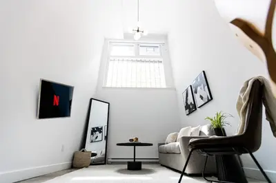 a living room with a couch and a mirror at Le Mile End by M11 - Modern Luxe 1BDR with Sofa Bed in Montréal