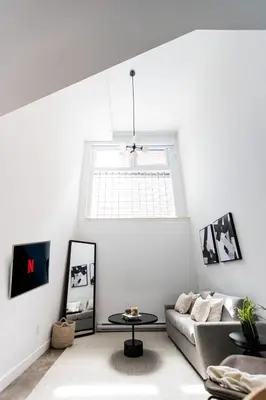 a living room with a couch and a table at Le Mile End by M11 - Luxury 1BDR Loft with Sofa Bed in Montréal