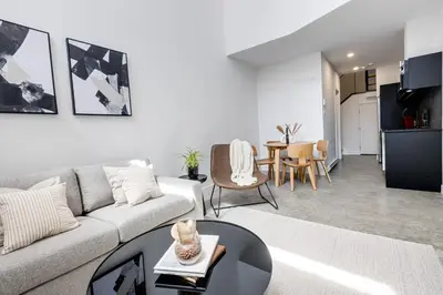 a living room with a couch and a table at Le Mile End by M11 - Luxury 1BDR Loft with Sofa Bed in Montréal