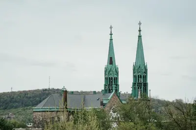 two towers of a building with trees in front of it at Welcoming and Light Filled 2bdr Apartment in Montréal
