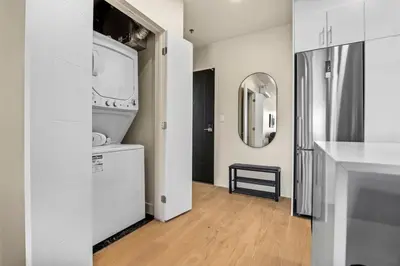 a white bathroom with a sink and a mirror at DownTown King Loft in Montréal