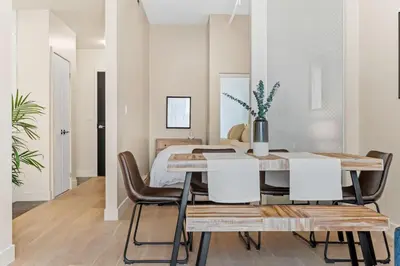 a dining room with a table and chairs at Stylish 2BR Retreat in Montréal