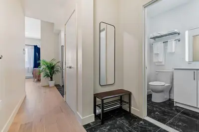 a bathroom with a toilet and a mirror at Downtown 2BR condo in Montréal