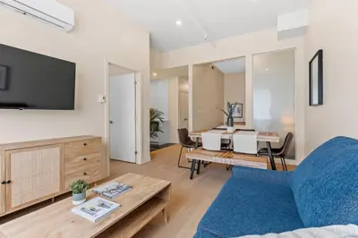 a living room with a couch and a table at Downtown 2BR condo in Montréal