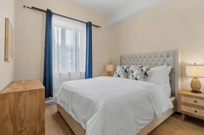 a bedroom with a large bed and a window at Downtown 2BR condo in Montréal