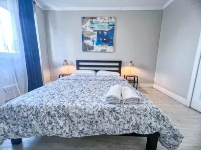 a bedroom with a bed with a comforter and pillows at Downtown Central Residences in Montréal