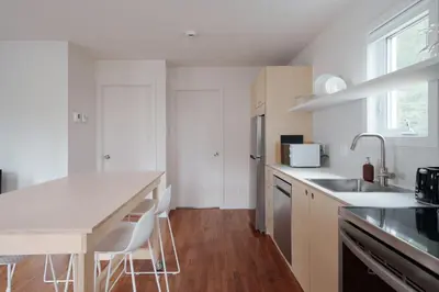a white kitchen with a sink and a counter top at Chalet 2 OST Shefford in Shefford