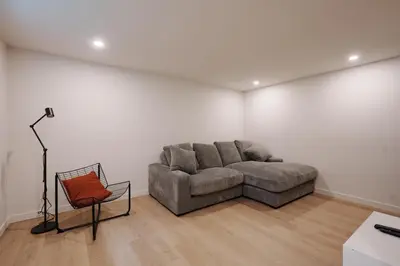 a living room with a couch and a chair at Chalet 4 OST Shefford in Shefford