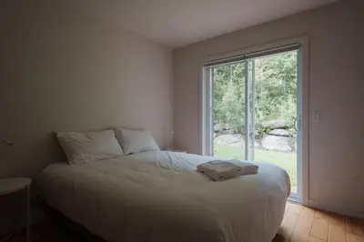 a bedroom with a bed and a large window at Chalet 5 OST Shefford in Shefford
