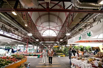 a group of people walking through a farmers market at Trendy Open-Space Studio by Jean Talon Market in Montréal