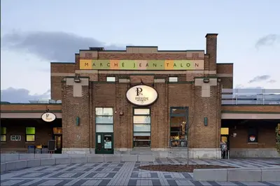 a building with a clock on the front of it at Trendy Open-Space Studio by Jean Talon Market in Montréal