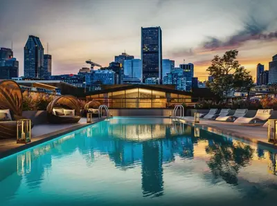 a swimming pool with a city skyline in the background at Penthouse with pool and parking in Montréal