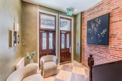 a lobby with chairs and a brick wall at Self Check-In Boutique Hotel - Quartier latin - Room 102 in Montréal
