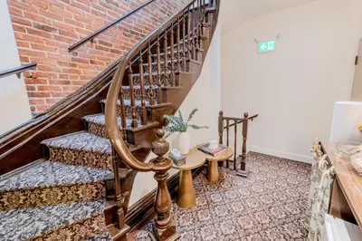 a stairwell with a brick wall and a wooden spiral staircase at Self Check-In Boutique Hotel - Quartier latin - Room 103 in Montréal