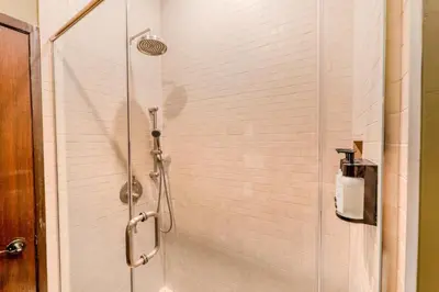 a shower with a glass door in a bathroom at Self Check-In Boutique Hotel - Quartier latin - Room 201 in Montréal
