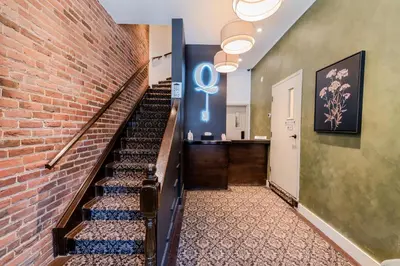 a staircase in a building with a brick wall at Self Check-In Boutique Hotel - Quartier latin - Room 202 in Montréal