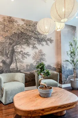 a living room with a table and two chairs and a mural at Self Check-In Boutique Hotel - Quartier latin - Room 203 in Montréal
