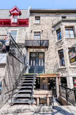 a building with stairs and a bench in front of it at Self Check-In Boutique Hotel - Quartier latin - Room 203 in Montréal