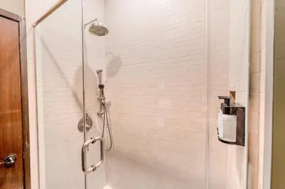 a shower with a glass door in a bathroom at Self Check-In Boutique Hotel - Quartier latin - Room 301 in Montréal