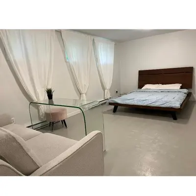 a bedroom with a bed and a glass table at Zen Space in perfect location! in Montréal