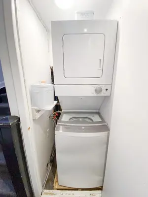 a white washer and dryer in a small room at #9 - Classic Studio - Self Check in - Plateau - St-Denis - AC - TV in Montréal