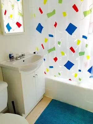 a bathroom with a shower curtain covered in confetti at Stylish Montreal Apartment Comfortable Stay in the Golden Square Mile in Montréal