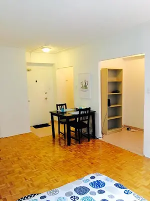 a dining room with a table and two chairs at Stylish Montreal Apartment Comfortable Stay in the Golden Square Mile in Montréal