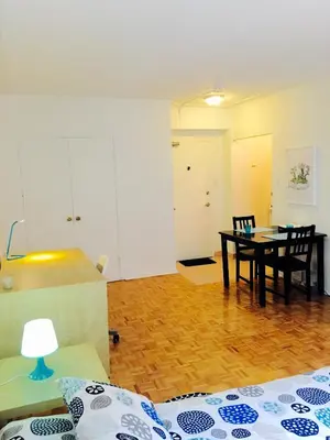 a living room with a table and a dining room at Stylish Montreal Apartment Comfortable Stay in the Golden Square Mile in Montréal
