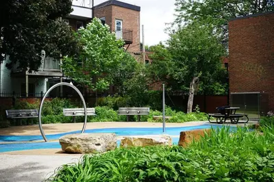 a park with two benches and two rocks at updated and cozy 2 bedroom unit, fully furnished, downtown, 32 days minimum in Montréal