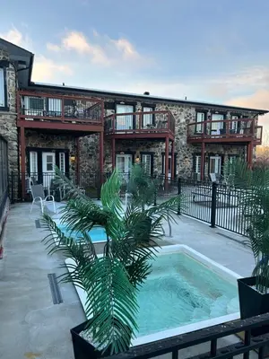 a house with a swimming pool in front of a building at Condos hotel lion d or in Magog-Orford