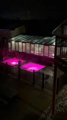 a building with pink lights in front of it at Condos hotel lion d or in Magog-Orford